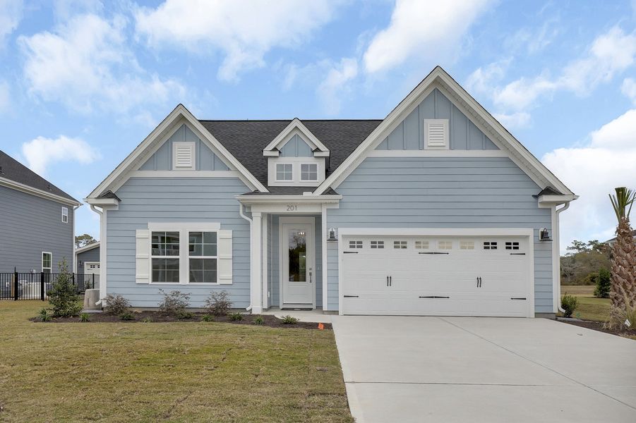 Front exterior of a new home in East Wynd, Hampstead, NC, highlighting curb appeal (Image 1).