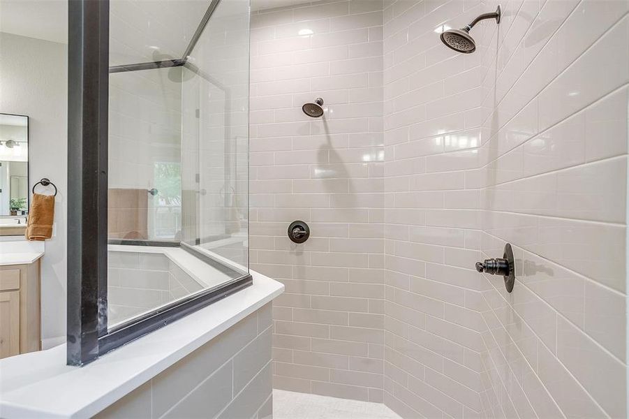 Full bath featuring vanity and tiled shower Full bath featuring vanity and tiled shower