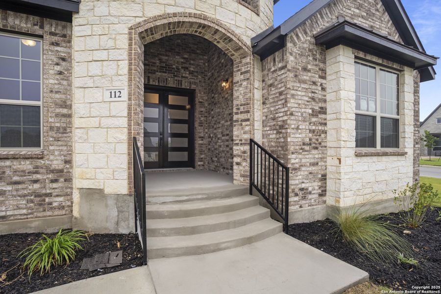 Front exterior of a new home in Potranco Oaks, Castroville, TX, highlighting curb appeal (Image 4).