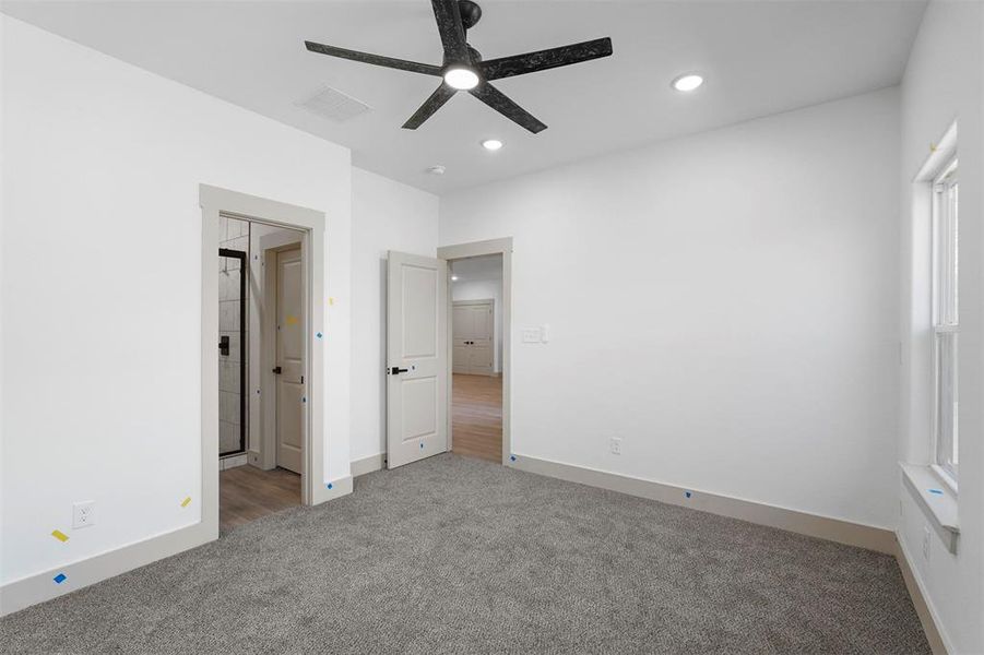 Unfurnished bedroom featuring a ceiling fan, carpet, visible vents, baseboards, and recessed lighting