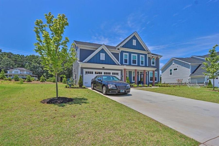 Front exterior of a new home in Sweetbay Farm, Lawrenceville, GA, highlighting curb appeal (Image 2).