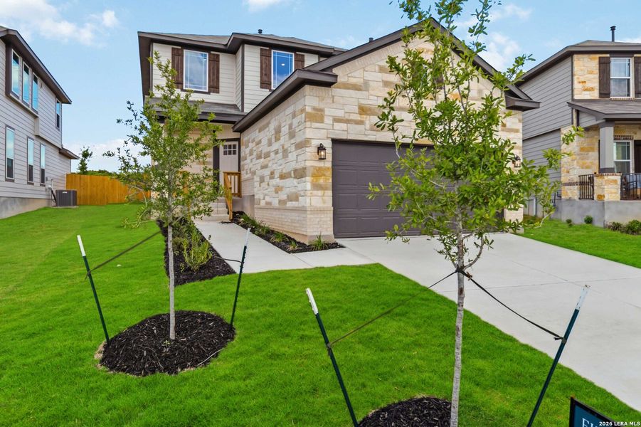 Front exterior of a new home in Hunters Ranch, San Antonio, TX, highlighting curb appeal (Image 21). Front exterior of a new home in Hunters Ranch, San Antonio, TX, highlighting curb appeal (Image 21).