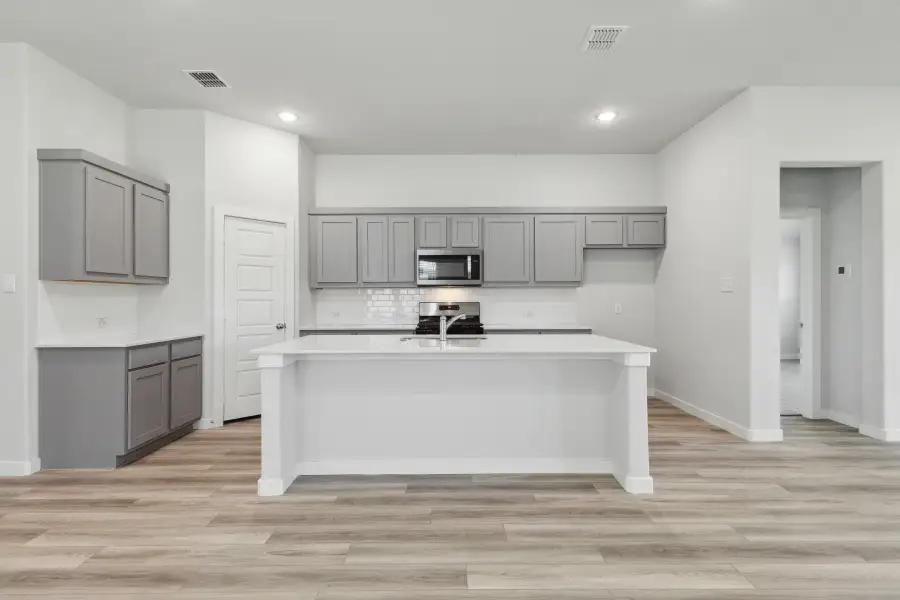 Kitchen in the Quartz home plan by Trophy Signature Homes – REPRESENTATIVE PHOTO