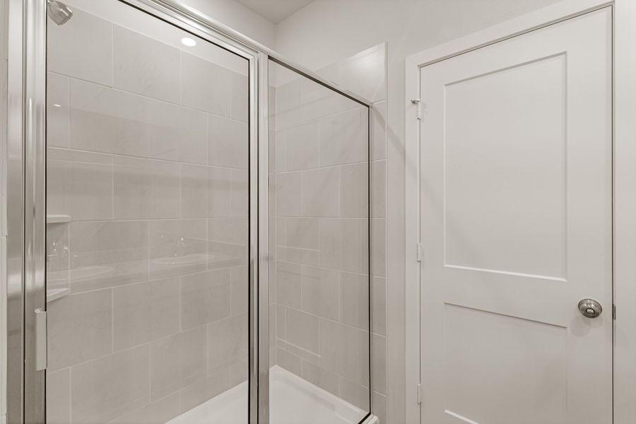 A shower with a glass door.