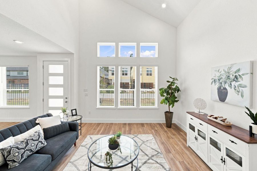 Bright living area with soaring ceilings, abundant natural light, and an open layout connecting seamlessly to the kitchen and breakfast area. Bright living area with soaring ceilings, abundant natural light, and an open layout connecting seamlessly to the kitchen and breakfast area.
