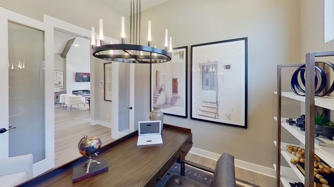 Home office featuring wood finished floors and hanging lights