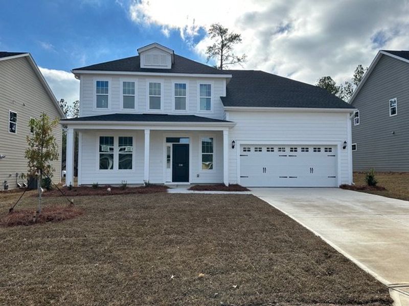 Front exterior of a new home in Pebble Branch, Chapin, SC, highlighting curb appeal (Image 1). Front exterior of a new home in Pebble Branch, Chapin, SC, highlighting curb appeal (Image 1).