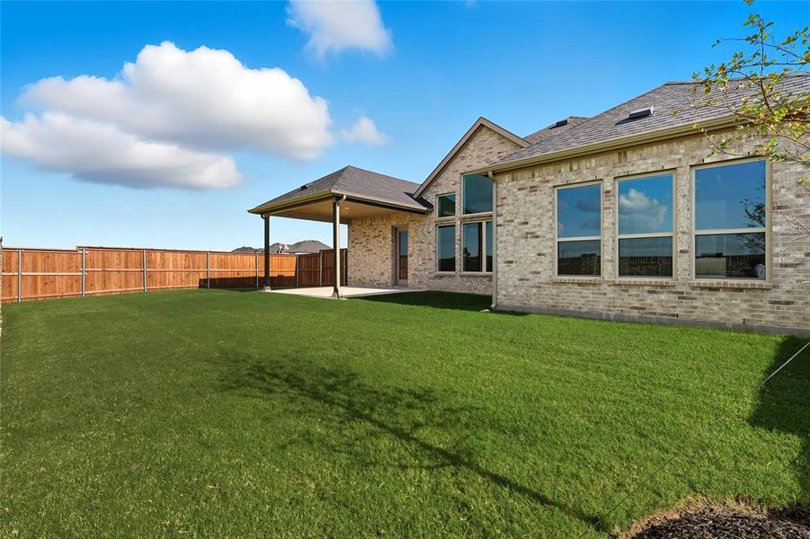 Rear view of property featuring a patio, brick siding, and a fenced backyard Rear view of property featuring a patio, brick siding, and a fenced backyard