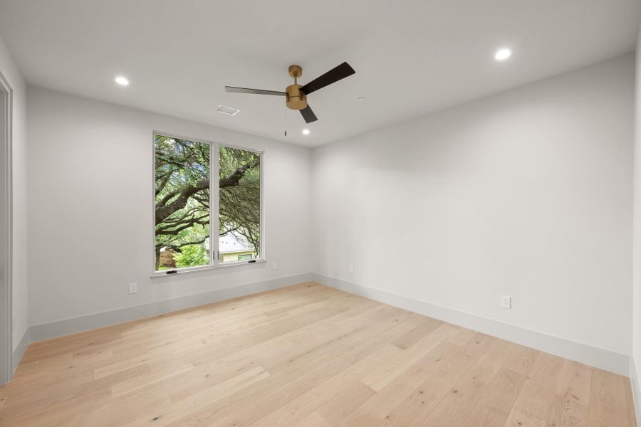 A tranquil sanctuary offering a contemporary ceiling fan and light wood flooring. A tranquil sanctuary offering a contemporary ceiling fan and light wood flooring.