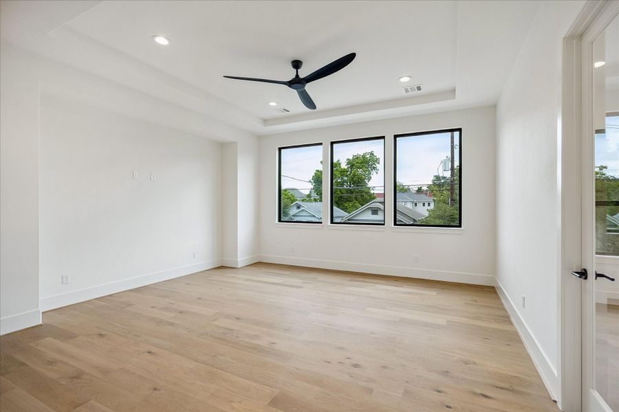 Game room – wide plank wood floor and tray ceiling with ceiling fan. Game room – wide plank wood floor and tray ceiling with ceiling fan.