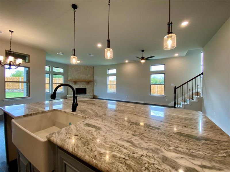 Massive kitchen island has pendant lighting for ambiance.