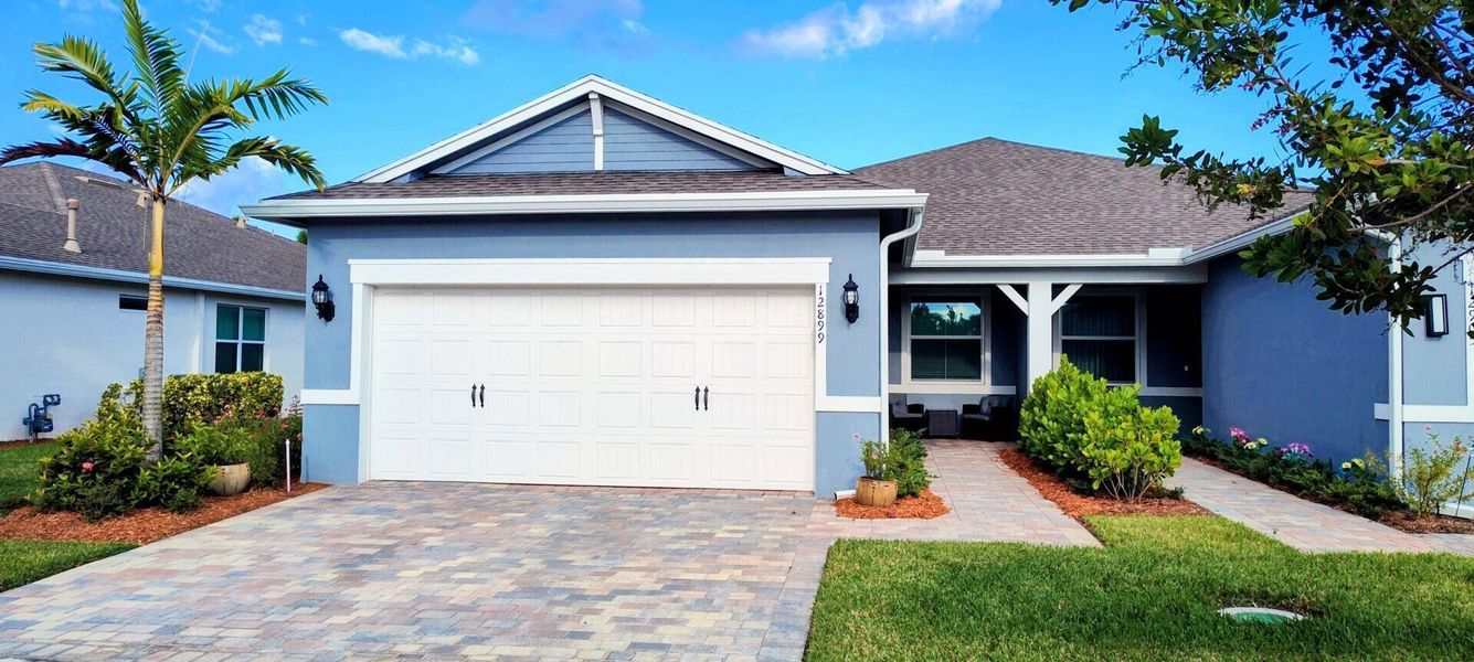Front exterior of a new home in Del Webb Tradition, Port St. Lucie, FL, highlighting curb appeal (Image 19).