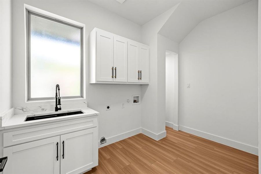 Large utility room with sink and extra tucked away storage.