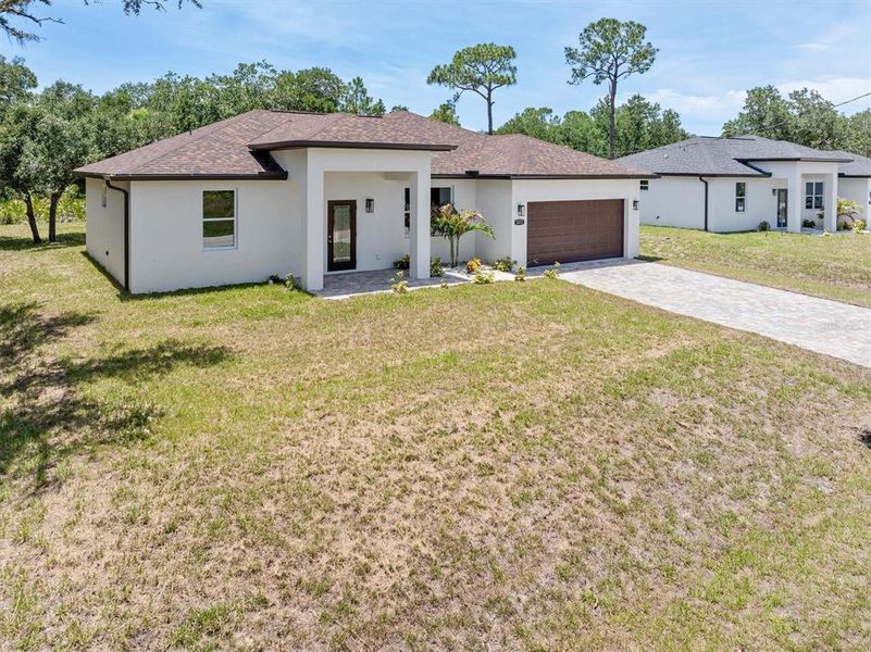 Front exterior of a new home in , North Port, FL, highlighting curb appeal (Image 22). Front exterior of a new home in , North Port, FL, highlighting curb appeal (Image 22).