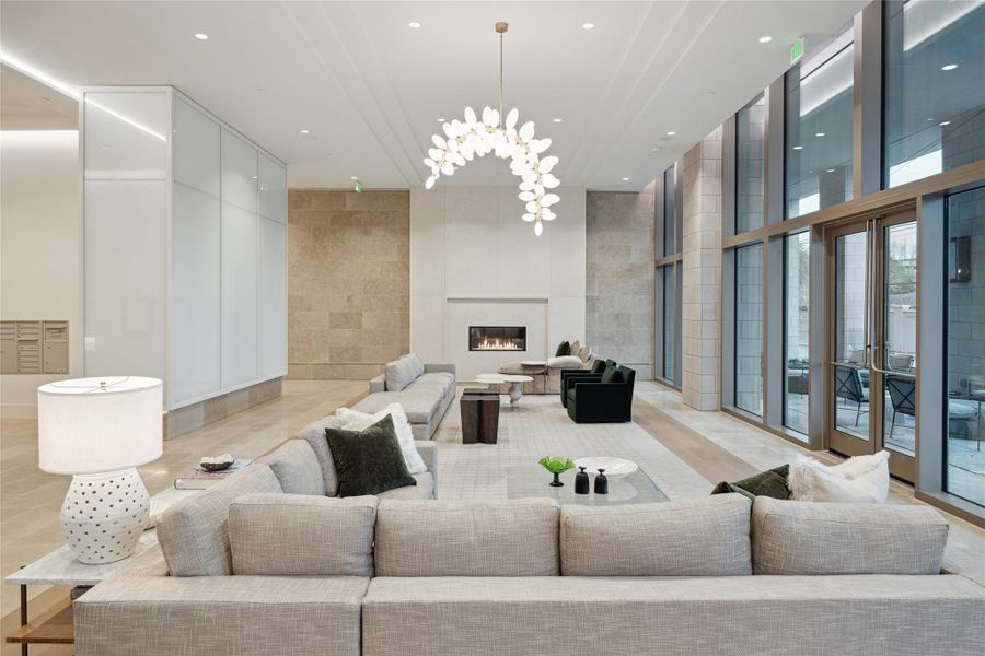 THE HAWTHORNE lobby.  A welcoming first impression with a soft neutral color palette and comfortable seating areas areas arranged alongside a gas fireplace and floor to ceiling windows overlooking out outdoor covered lounge