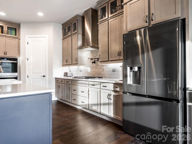 1st Flr, Kitchen; view of 5-burner gas cooktop, pot-filler and walk-in pantry