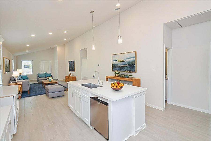 Pendant lighting over the island and recessed lighting throughout the room illuminate the space beautifully. Pendant lighting over the island and recessed lighting throughout the room illuminate the space beautifully.