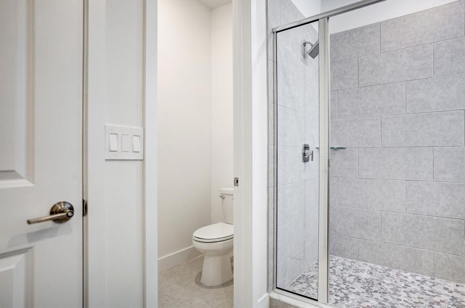 Shower with natural stone flooring