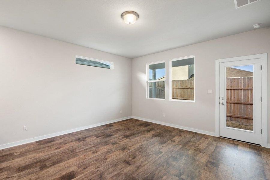 Spare room with dark wood finished floors and baseboards