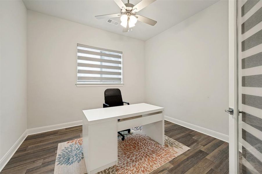 Dedicated room featuring wood-finish flooring and a contemporary ceiling fan