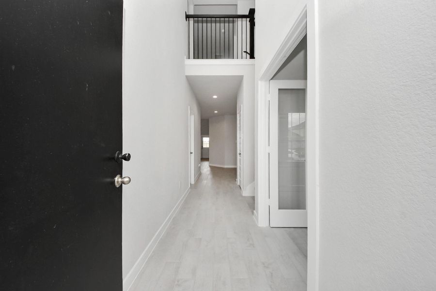 The grand entrance welcomes you with tile floors, oversized baseboards, and recessed lighting, setting the stage for a luxurious journey. Follow the Long Walkway to discover the open-concept kitchen and family room, where elegance meets comfort seamlessly. Sample photo of completed home with similar floor plan. Actual colors and selections may vary. The grand entrance welcomes you with tile floors, oversized baseboards, and recessed lighting, setting the stage for a luxurious journey. Follow the Long Walkway to discover the open-concept kitchen and family room, where elegance meets comfort seamlessly. Sample photo of completed home with similar floor plan. Actual colors and selections may vary.