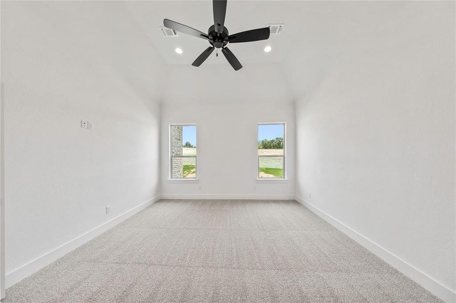 Spare room with light colored carpet, recessed lighting, vaulted ceiling, and ceiling fan Spare room with light colored carpet, recessed lighting, vaulted ceiling, and ceiling fan