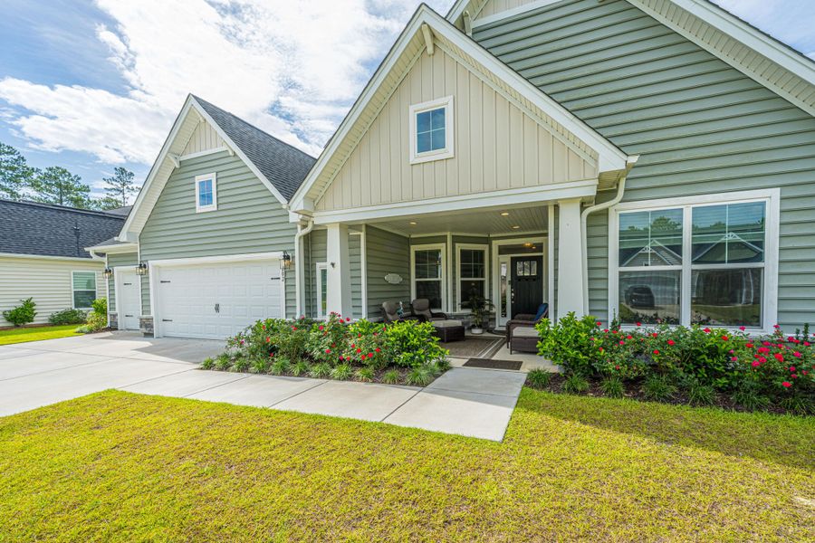 Front exterior of a new home in The Enclave at French Quarter Creek, Huger, SC, highlighting curb appeal (Image 1). Front exterior of a new home in The Enclave at French Quarter Creek, Huger, SC, highlighting curb appeal (Image 1).