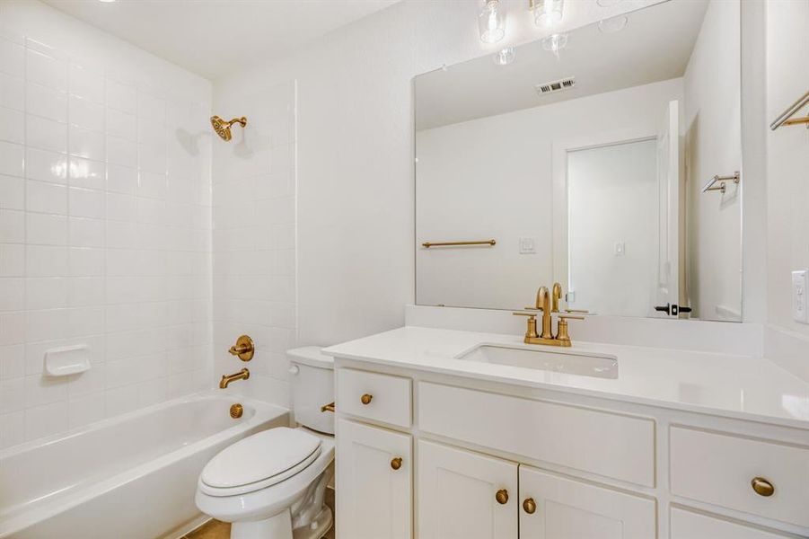 Bathroom with vanity and bathing tub / shower combination