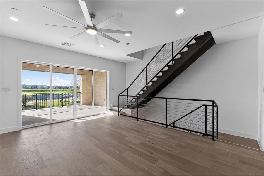 Unfurnished living room featuring ceiling fan, light wood-style floors, and recessed lighting