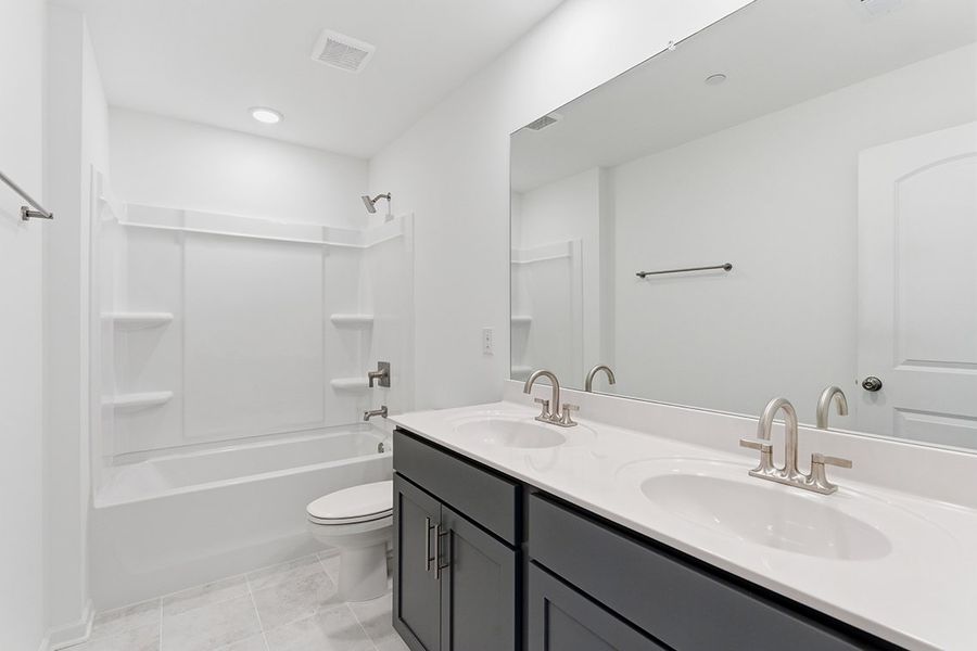 A bathroom with a tub sink and toilet. A bathroom with a tub sink and toilet.