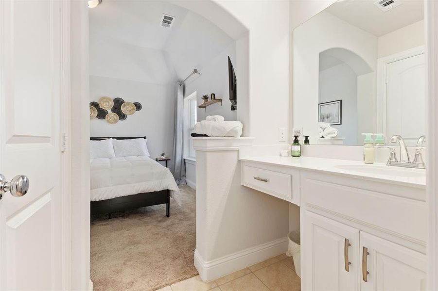 Bathroom featuring tile floors and vanity