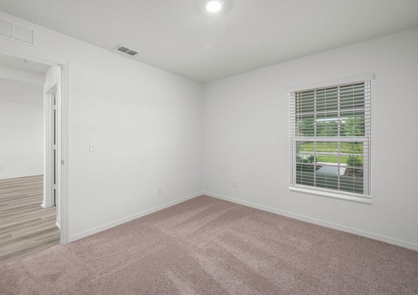 A secondary bedroom with carpet
