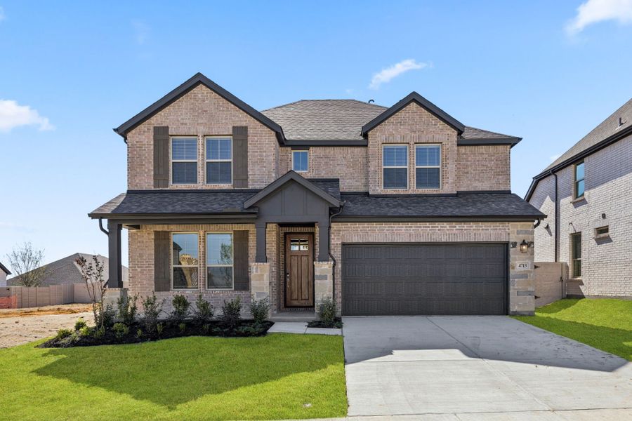 Front exterior of a new home in Painted Tree Woodland West, McKinney, TX, highlighting curb appeal (Image 21).