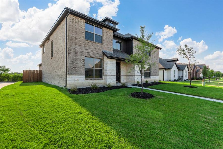 View of front of house with brick siding and stone siding View of front of house with brick siding and stone siding