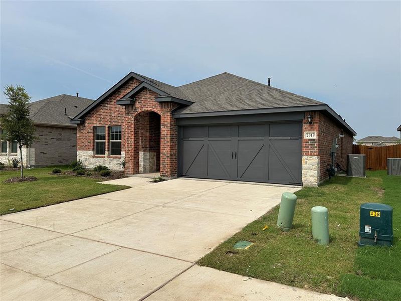 Front exterior of a new home in Cartwright Ranch, Crandall, TX, highlighting curb appeal (Image 2). Front exterior of a new home in Cartwright Ranch, Crandall, TX, highlighting curb appeal (Image 2).