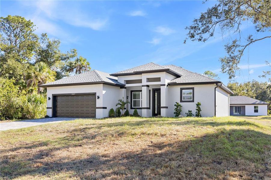 Front exterior of a new home in , Port Charlotte, FL, highlighting curb appeal (Image 24).