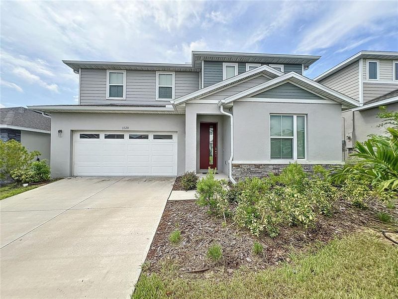 Front exterior of a new home in Seasons at Forest Lake, Davenport, FL, highlighting curb appeal (Image 1). Front exterior of a new home in Seasons at Forest Lake, Davenport, FL, highlighting curb appeal (Image 1).