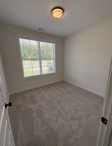Room featuring neutral-toned carpeting and light-colored walls Room featuring neutral-toned carpeting and light-colored walls