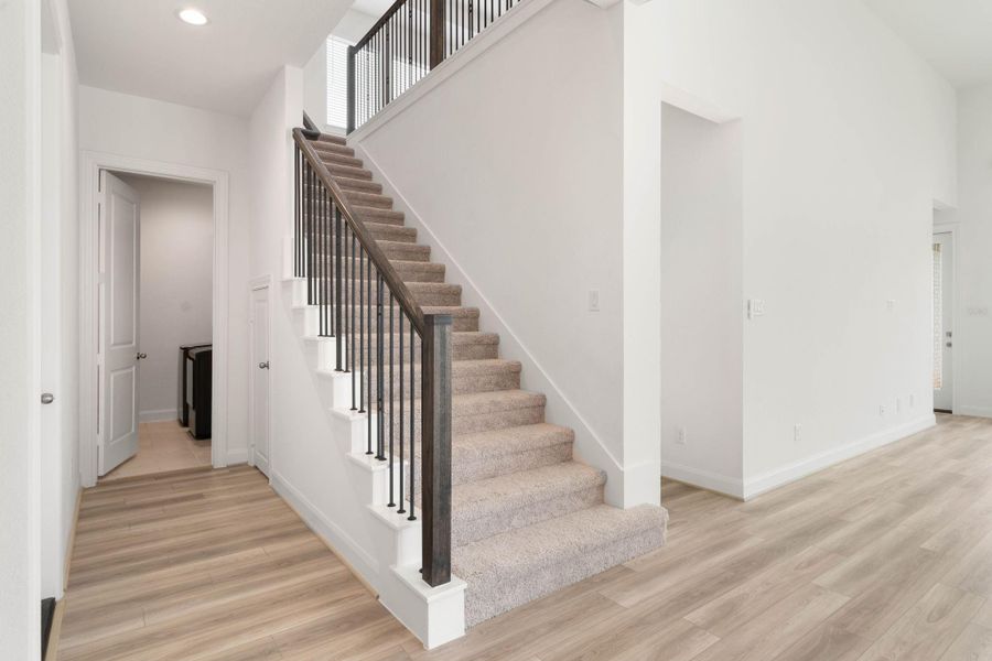 Off the stairs you will find the utility room with brand new washer and dryer, a lighted understair storage area, and access to the 3 car garage.
