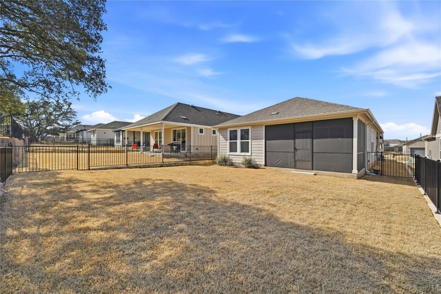 Back of property featuring a fenced backyard