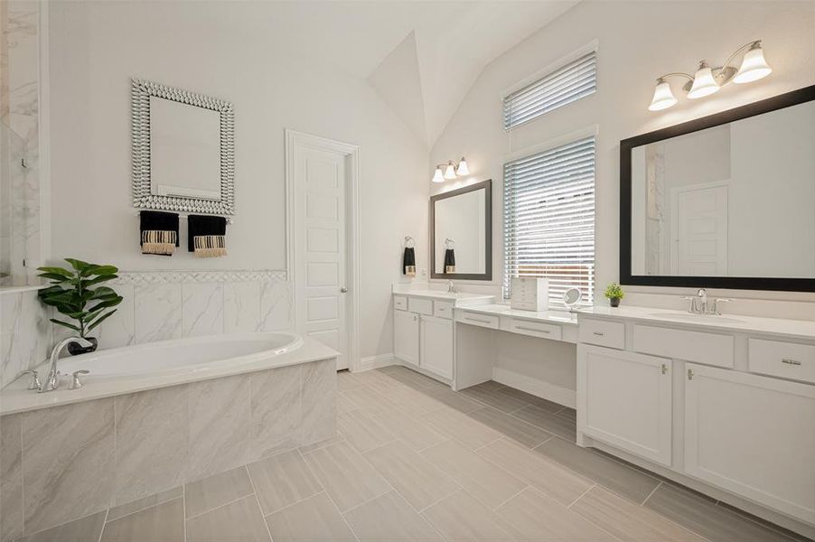 ndulge in this spacious primary bathroom designed with both comfort and functionality in mind. Featuring an expansive dual-sink vanity, abundant cabinet storage, and oversized framed mirrors, this elegant space offers plenty of room for busy mornings. The bright, neutral finishes and open layout create a spa-like atmosphere, while the large soaking tub provides the perfect place to relax and unwind after a long day. ndulge in this spacious primary bathroom designed with both comfort and functionality in mind. Featuring an expansive dual-sink vanity, abundant cabinet storage, and oversized framed mirrors, this elegant space offers plenty of room for busy mornings. The bright, neutral finishes and open layout create a spa-like atmosphere, while the large soaking tub provides the perfect place to relax and unwind after a long day.