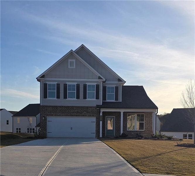 Front exterior of a new home in River Oaks, Locust Grove, GA, highlighting curb appeal (Image 2).