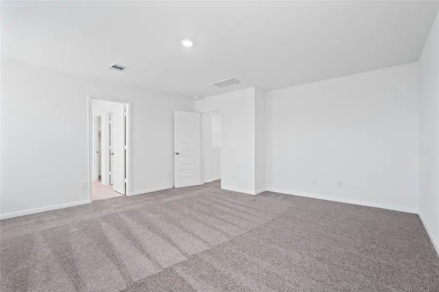 Additional view from primary bedroom looking to entrance to primary bathroom. Additional view from primary bedroom looking to entrance to primary bathroom.