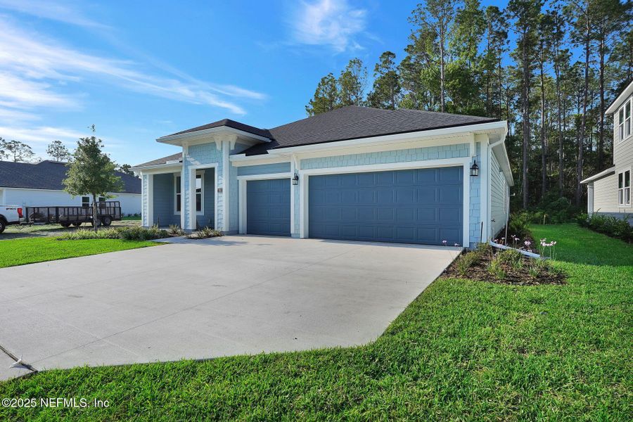 Front exterior of a new home in Trailmark - Phase 10, St. Augustine, FL, highlighting curb appeal (Image 19).