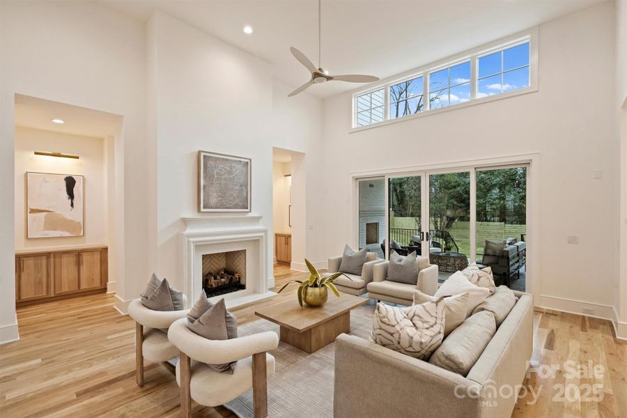 The custom Tudor stone gas fireplace adds an elegant and cozy ambiance to the great room.