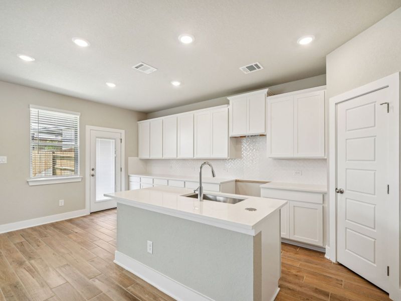 Kitchen in the Red River floorplan at a Meritage Homes community.