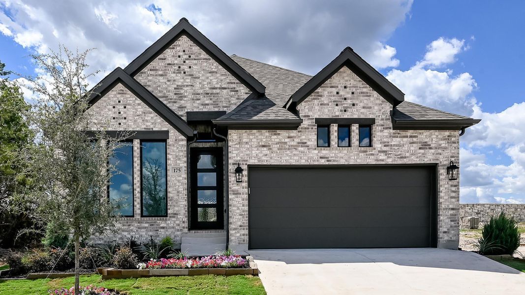 View of front of property featuring driveway, brick siding, an attached garage, and a shingled roof View of front of property featuring driveway, brick siding, an attached garage, and a shingled roof