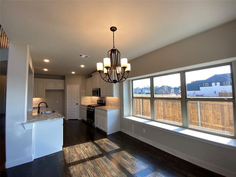 Nice dining area with window seat & chandelier