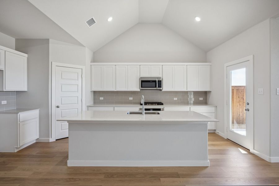 Kitchen in the Wimbledon home plan by Trophy Signature Homes – REPRESENTATIVE PHOTO