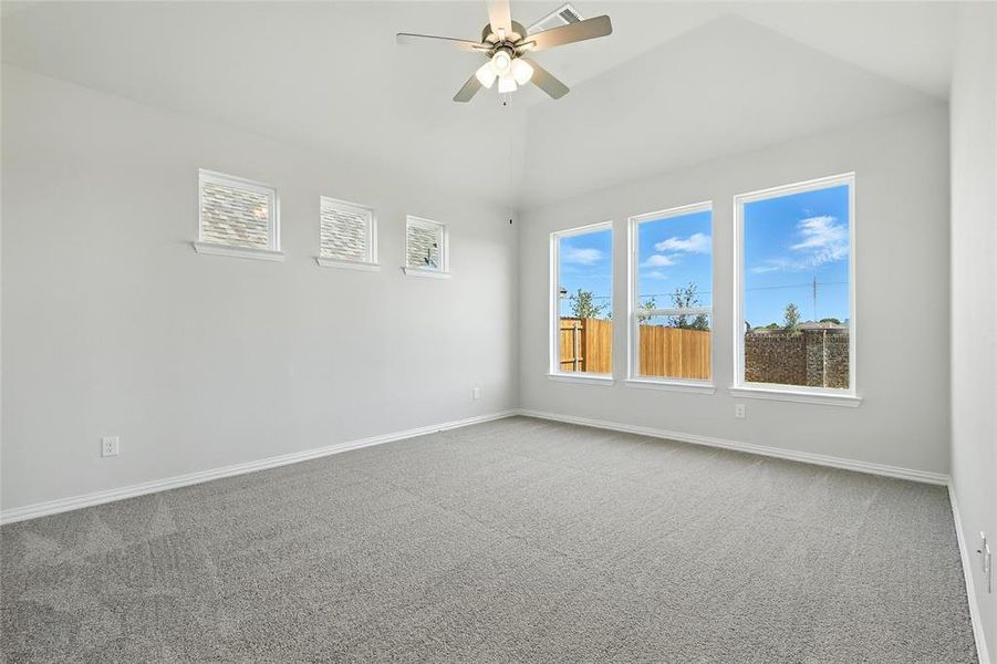 Spare room featuring carpet flooring, ceiling fan, and high vaulted ceiling Spare room featuring carpet flooring, ceiling fan, and high vaulted ceiling